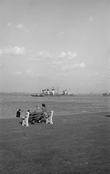 Two holidaymakers look out to sea on the promenade at Gravesend, Kent, c1945-c1965. Artist: SW Rawlings