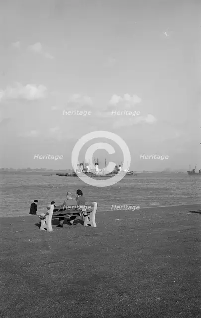 Two holidaymakers look out to sea on the promenade at Gravesend, Kent, c1945-c1965. Artist: SW Rawlings