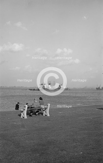 Two holidaymakers look out to sea on the promenade at Gravesend, Kent, c1945-c1965. Artist: SW Rawlings