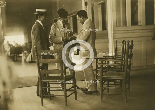 Two Japanese men and one American(?) man, probably journalists, conversing on the veranda..., 1905. Creator: Unknown.