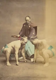 Two Japanese sumo wrestlers posed with referee, 1868-1880. Creator: Felice Beato
