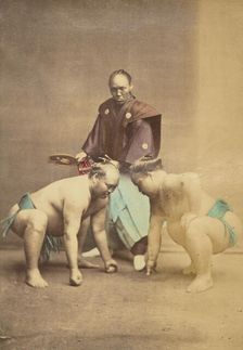 Two Japanese sumo wrestlers posed with referee, 1868-1880. Creator: Felice Beato