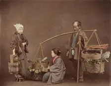 Two Japanese Women and One Japanese Man Posing with Water Bucket and Baskets], 1870s. Creator: Unknown