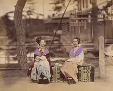 [Two Japanese Women Sitting on a Bench], 1870s. Creator: Unknown