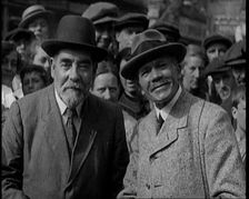 Two Labour Politicians Talking to Each Other, Surrounded by Supporters, 1921. Creator: British Pathe Ltd