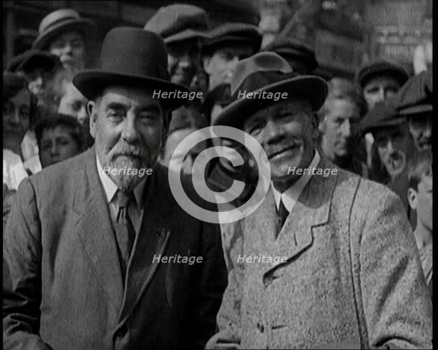 Two Labour Politicians Talking to Each Other, Surrounded by Supporters, 1921. Creator: British Pathe Ltd.