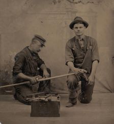 Two Plumbers with a Pipe, Pipe Cutter, and Toolbox, 1870s-80s. Creator: Unknown
