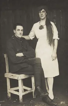 Two prisoners of war, one in drag, pose with a chair, [between 1910 and 1919?]. Creator: Unknown