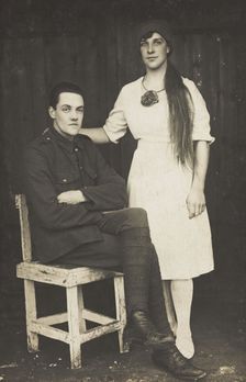 Two prisoners of war, one in drag, pose with a chair, [between 1910 and 1919?]. Creator: Unknown