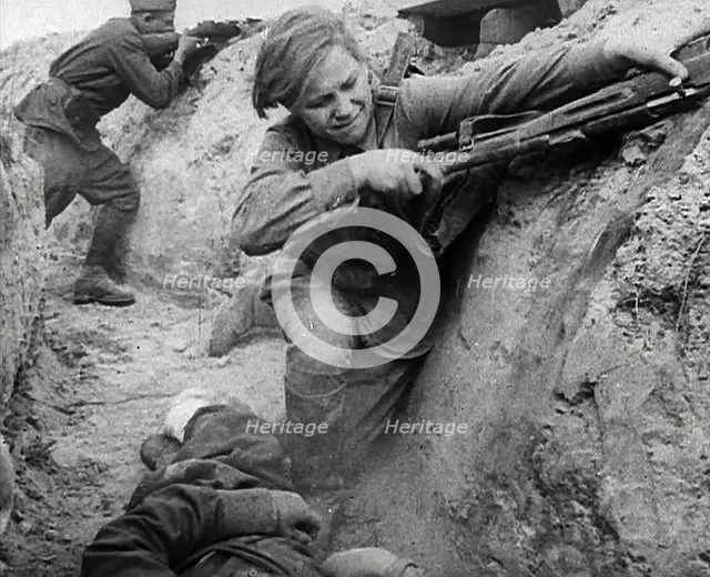 Two Russian Soldiers Taking Cover in a Trench, 1941. Creator: British Pathe Ltd.