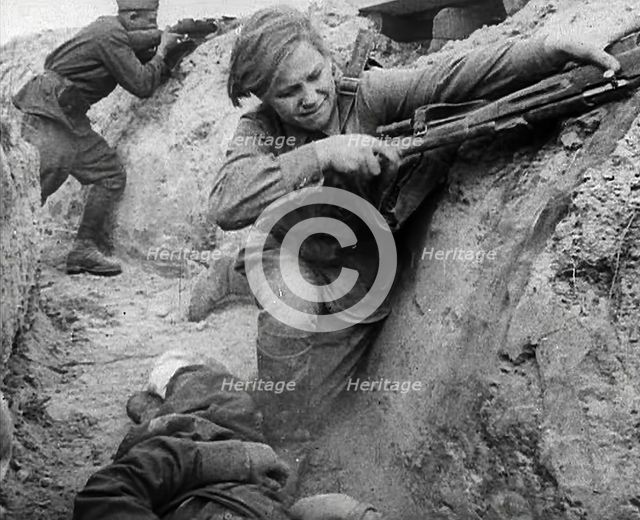 Two Russian Soldiers Taking Cover in a Trench, 1941. Creator: British Pathe Ltd.