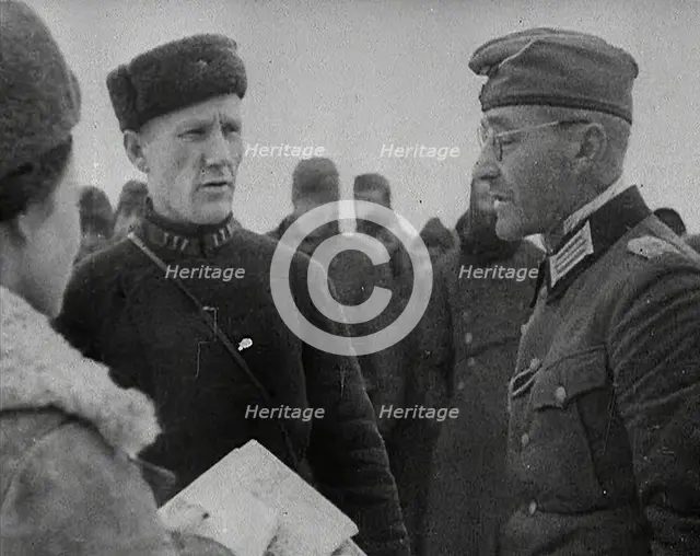 Two Russian Soldiers Talking to a German Prisoner of War, 1941. Creator: British Pathe Ltd.