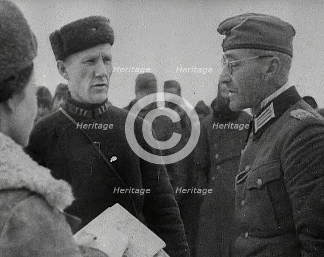 Two Russian Soldiers Talking to a German Prisoner of War, 1941. Creator: British Pathe Ltd.