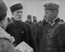Two Russian Soldiers Talking to a German Prisoner of War, 1941. Creator: British Pathe Ltd