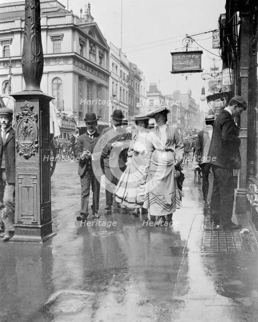 Two suffragettes walking along a pavement, London, 1900s. Creator: Unknown.