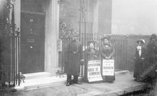 Two suffragettes outside No 10 attempt to speak to the Prime Minister, January 1909