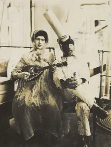 Two sailors (?) on board ship: one in drag is playing a guitar, 1907. Creator: Unknown