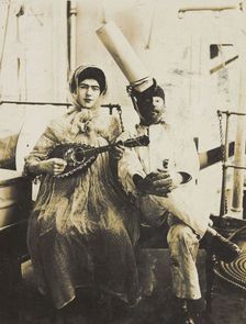 Two sailors (?) on board ship: one in drag is playing a guitar, 1907. Creator: Unknown