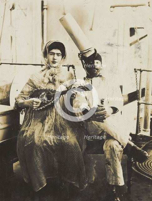 Two sailors (?) on board ship: one in drag is playing a guitar, 1907. Creator: Unknown.