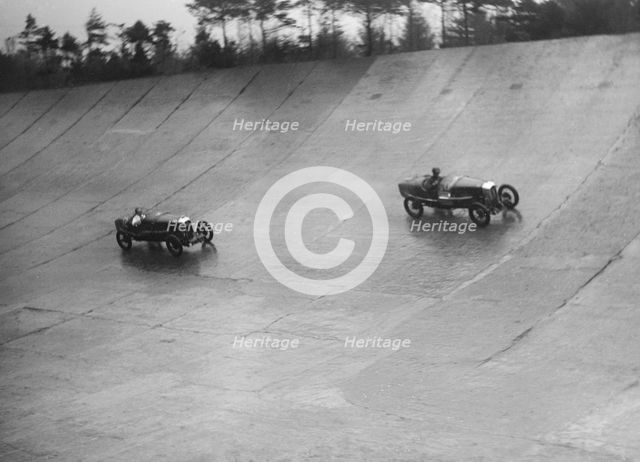 Two Salmsons racing on the banking at a BARC meeting, Brooklands, Surrey, 1931 Artist: Bill Brunell.