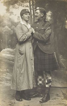 Two soldiers playing in a military concert party embrace: one is in drag and the ..., [1910-1919]. Creator: Unknown