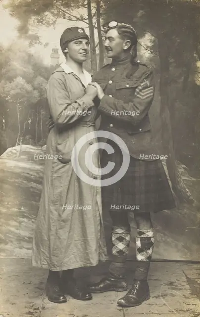 Two soldiers playing in a military concert party embrace: one is in drag and the ..., [1910-1919]. Creator: Unknown.