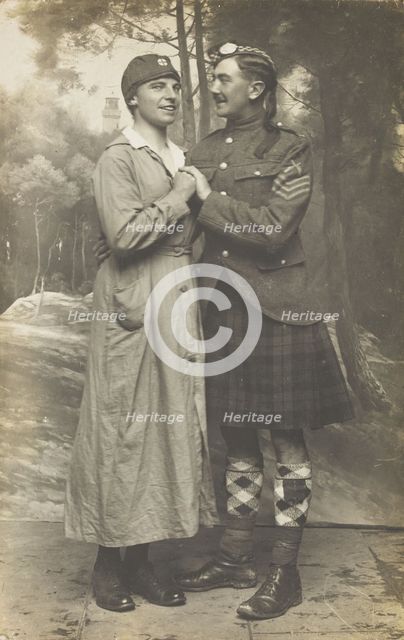 Two soldiers playing in a military concert party embrace: one is in drag and the ..., [1910-1919]. Creator: Unknown.