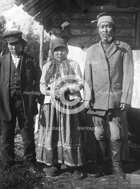Two Tungus men and a woman with a cross on her chest, 1920-1939. Creator: Unknown.