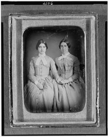 Two unidentified women, three-quarter length portraits, seated, between 1851 and 1860. Creator: H. R. Marks