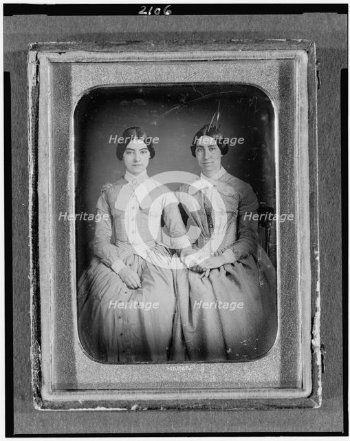 Two unidentified women, three-quarter length portraits, seated, between 1851 and 1860. Creator: H. R. Marks.