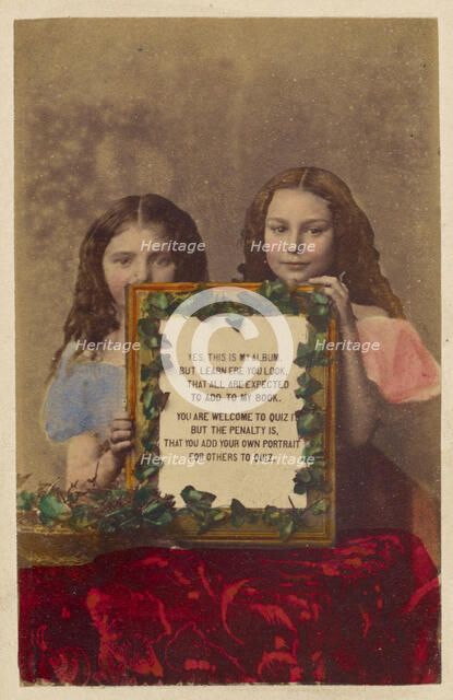 Two unidentified girls holding a framed picture with text, 1870-1875. Creator: Burgwitz & Company.
