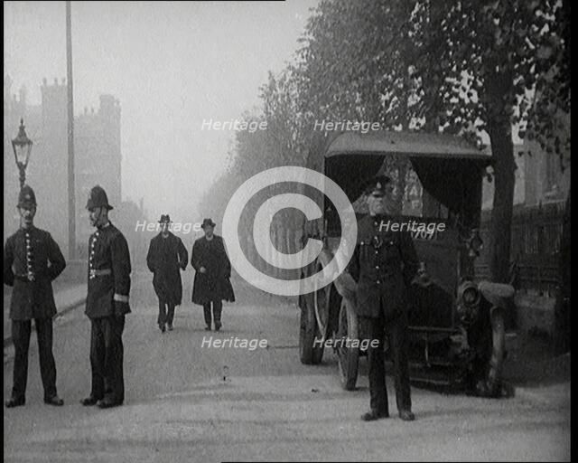 Two Vicars Walking Past Policemen Outside Brixton Prison, 1920. Creator: British Pathe Ltd.