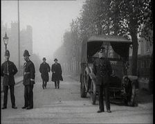 Two Vicars Walking Past Policemen Outside Brixton Prison, 1920. Creator: British Pathe Ltd