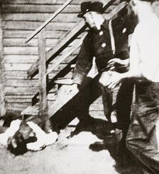 Two white men stoning an African American to death, 1919