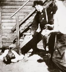 Two white men stoning an African American to death, 1919. Creator: Unknown