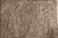 Two winged protective spirits before the sacred tree of life