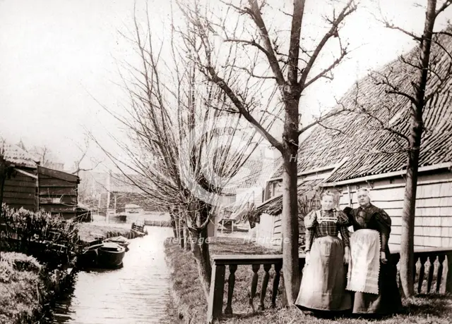 Two women on a canal bank, Broek, Netherlands, 1898.Artist: James Batkin