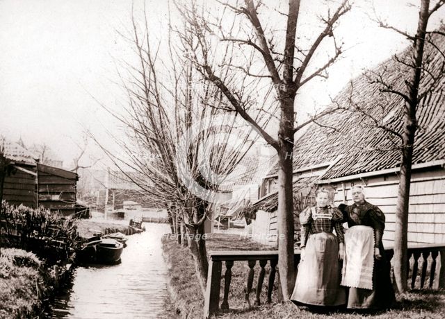 Two women on a canal bank, Broek, Netherlands, 1898.Artist: James Batkin