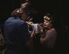 Two women employees of North American Aviation, Incorporated, assembling a section of a..., 1942. Creator: Alfred T Palmer