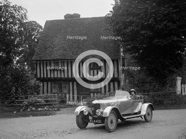 Two women in a AC motor car in front of a Tudor house, c1930s Artist: Bill Brunell.
