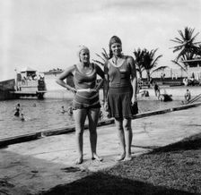 Two women in swimsuits beside a swimming pool, Balboa, Panama, 1931