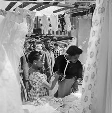 Two women looking at a stall in the Petticoat Lane Market, Whitechapel, London, c1946-c1959. Artist: John Gay