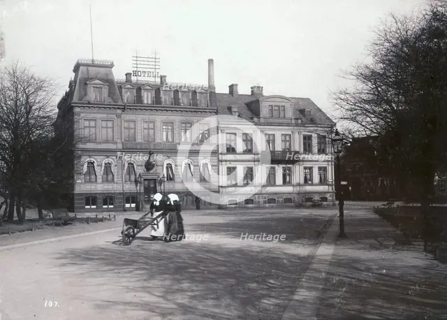 Two women with a wheelbarrow on their way to the fish market, Landskrona, Sweden, 1900. Creator: Borg Mesch.