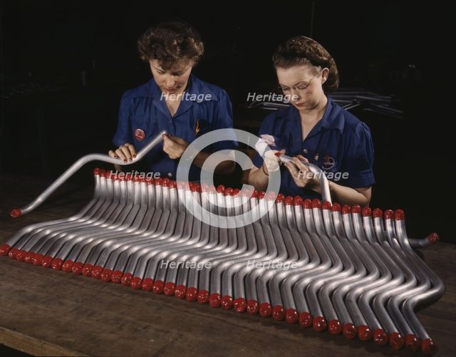 Two women workers are shown capping and inspecting tubing...Vultee's Nashville..., Tennessee, 1943. Creator: Alfred T Palmer.