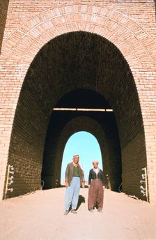 Two workmen outside the Mashki Gate, Nineveh, Iraq, 1977. Creator: Vivienne Sharp