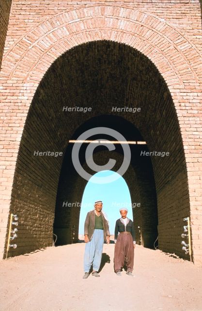 Two workmen outside the Mashki Gate, Nineveh, Iraq, 1977. Creator: Vivienne Sharp.