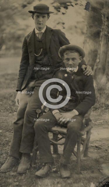 Two Young Men Outdoors, One Seated, the Other on the Arm of the Chair, 1880s. Creator: Unknown.