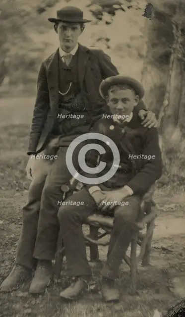 Two Young Men Outdoors, One Seated, the Other on the Arm of the Chair, 1880s. Creator: Unknown.