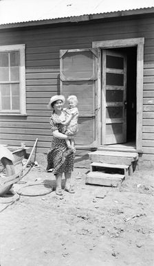 Typical Teutonic farm wife and child of Mills, New Mexico, area, 1935. Creator: Dorothea Lange