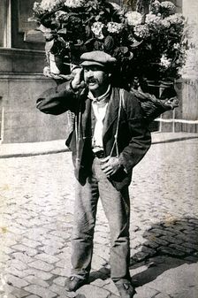 Typical picture of a street vendor of flowers, 1910